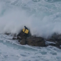 bodyboarder washed over rocks